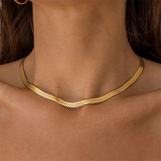 Gold necklace on a person's neck