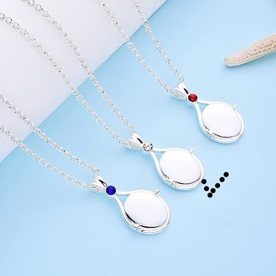 Silver necklaces with round pendants on a light blue background